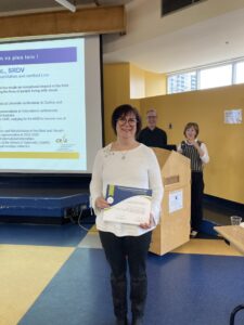 Hana Boxerman holding her prize at the CRIR AGA