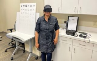 Sarika in her lab wearing virtual reality goggles.